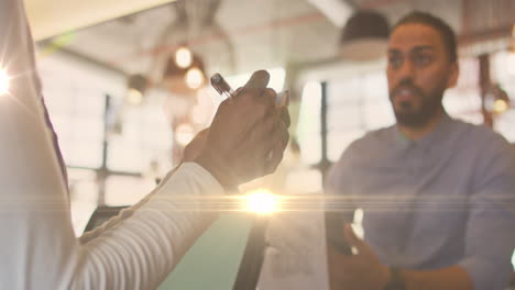 animation of light spots over biracial man ordering at cafe