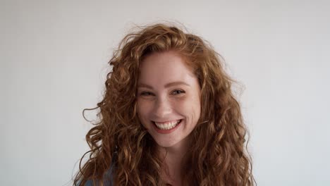 Portrait-of-laughing-young-caucasian-woman-on-white-background