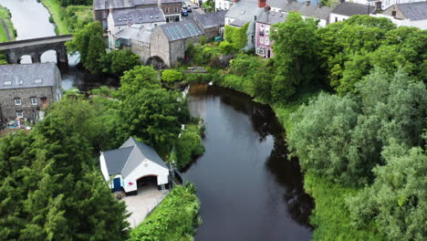 Aerial-shot-of-historic-rural-village-with-stone-architecture-and-bridge