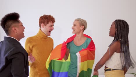 diverse group of friends joyfully celebrating with a pride flag