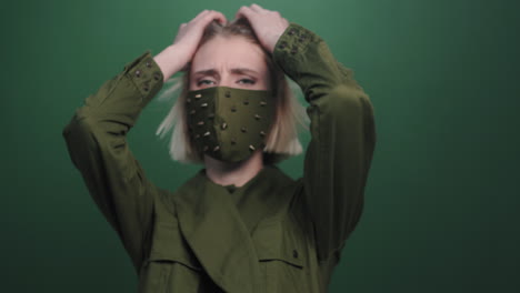 female model in studded face mask posing