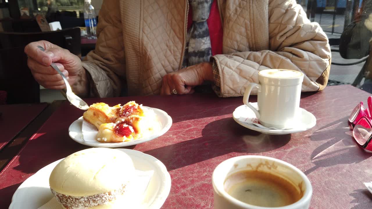 Served coffee table with french pastry and caramel cookies, espresso coffee close up view with sunshine, café
