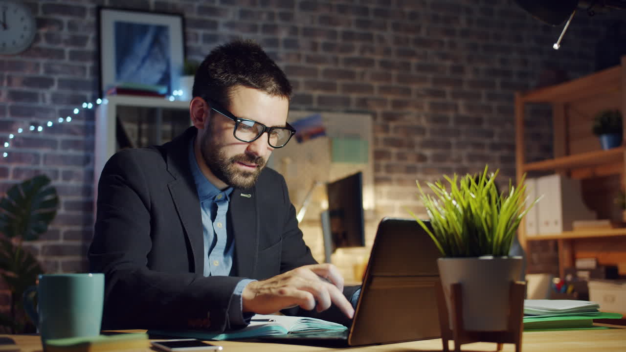 Businessman Working Late at Night in Home Office