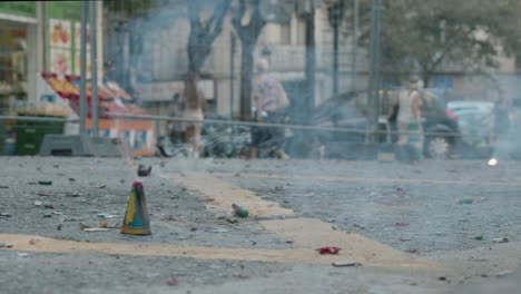 kid lighting a fuse of a firecracker on las fallas