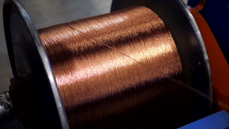 copper wire unwinding from a spool. closeup