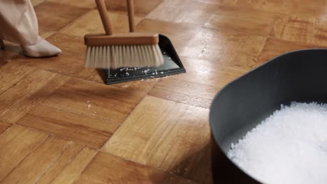 close up of woman sweeping the floor in heels, domestic household maintenance concept