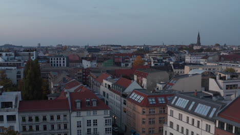 Evening-forwards-fly-above-urban-district.-Multistorey-apartment-buildings-along-streets.-Berlin,-Germany