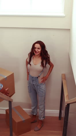 happy couple carrying cardboard