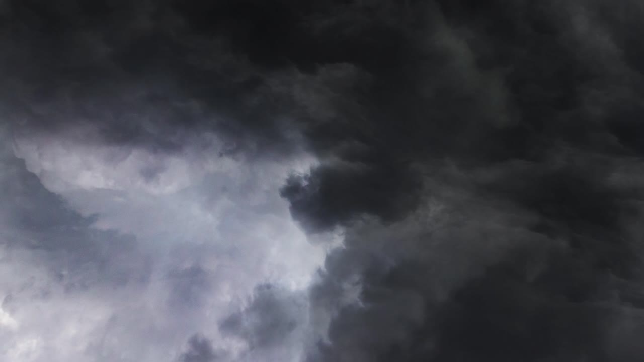 a thunderstorm inside a thick, dark gray cloud in the sky
