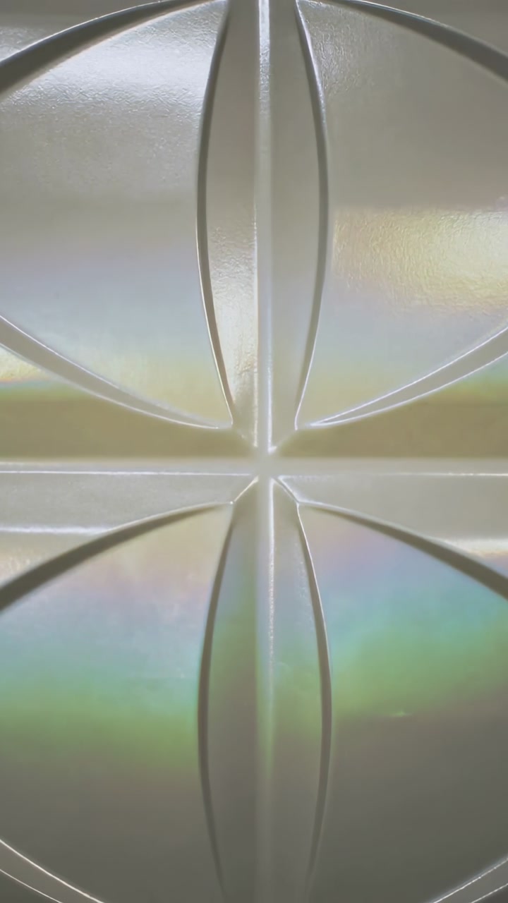 Vertical video: Showing relief panel shifting color bands on wall, off cam light moving highlights