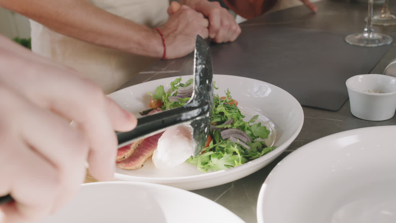 Close-up of a Chef Assembling a Salad