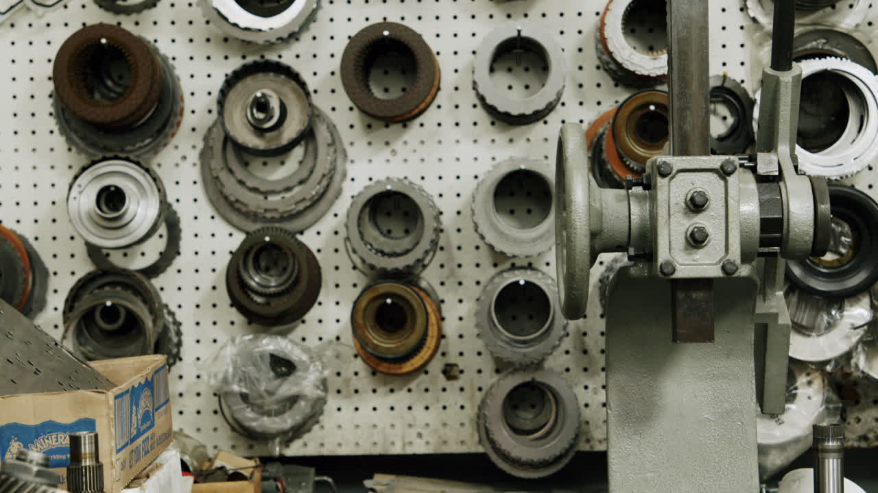 Close-up of various auto parts on a pegboard