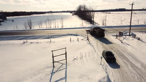 Winter-Driving-in-Canada:-Aerial-Footage-of-Yellow-School-Bus-and-Snowplow