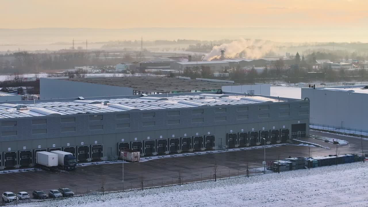 Modern distribution center with loading docks in winter landscape, Czechia