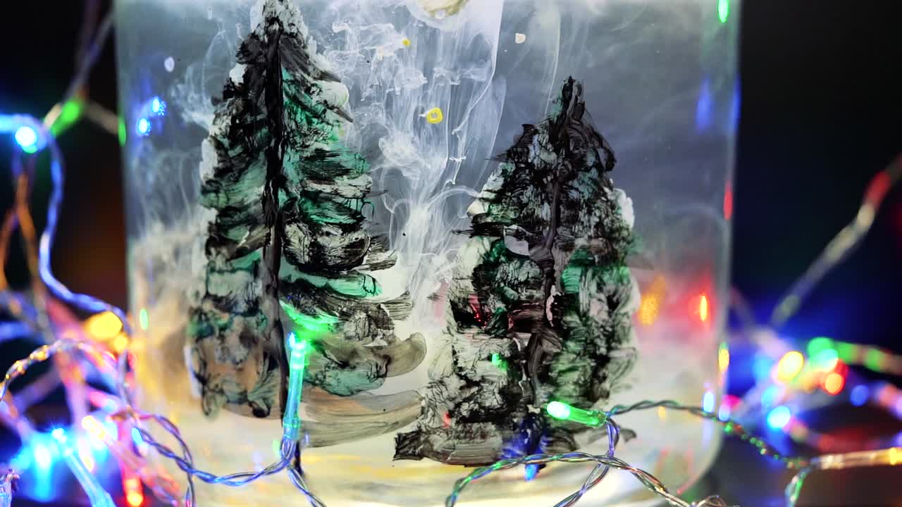 Colored paint floating in water tank surrounded by Christmas lights. Stable shot with the Sony a7iii