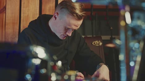 musician writing sheet music in a recording studio