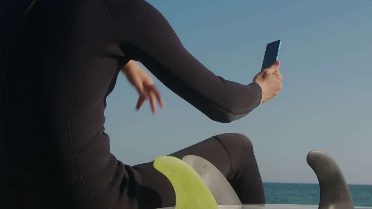 Surfer man walking to the beach at sunset preparing for surfing training and search for waves in Barcelona, spain, water, ocean exercise in sea with board, athletic male holiday or travel in vacation