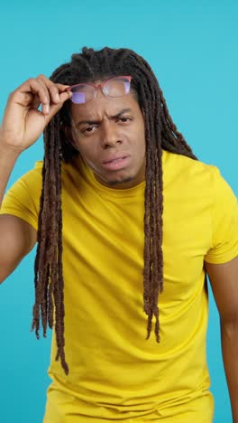 man with dreadlocks and glasses