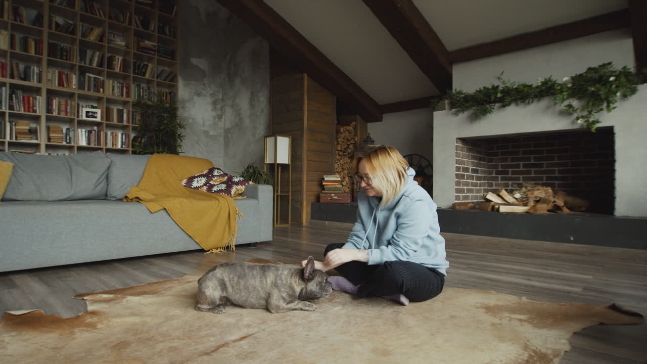 рыжеволосая женщина и ее собака бульдог на ковре на полу в гостиной 2