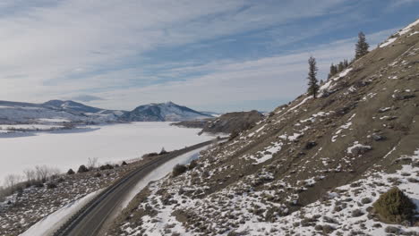 Aerial-shot-of-Cars-driving-down-a-moutain-road