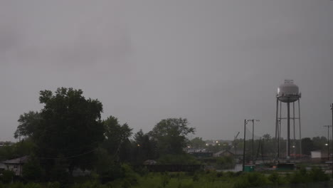 water tower in a park during a thunder storm