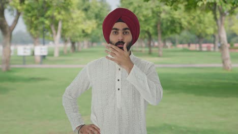 upset sikh indian man getting a shocking news in park