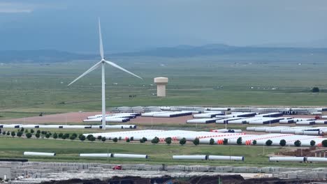 wind turbine spinning on windmill parts manufacturing site