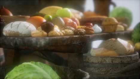 food table with wine barrels and some fruits, vegetables and bread