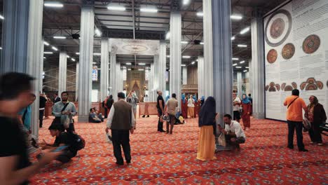 the blue mosque interior or sultanahmet indoors in istanbul city in turkey. the blue mosque interior or sultanahmet indoors with moving people in istanbul city