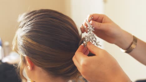 laying a groom brooch in blonde hair