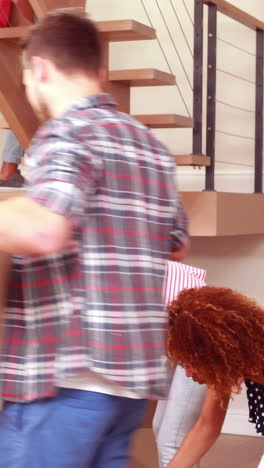 smiling friends moving boxes together