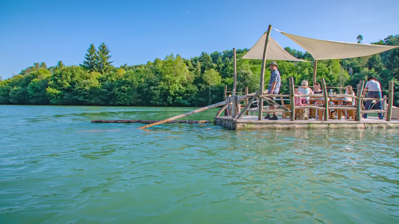 oar splashing on the water. Log raft adventure on Drava river. Arc shot