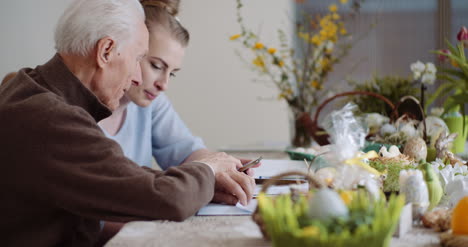 Granddaughter-With-Grandfather-Using-Digital-Tablet