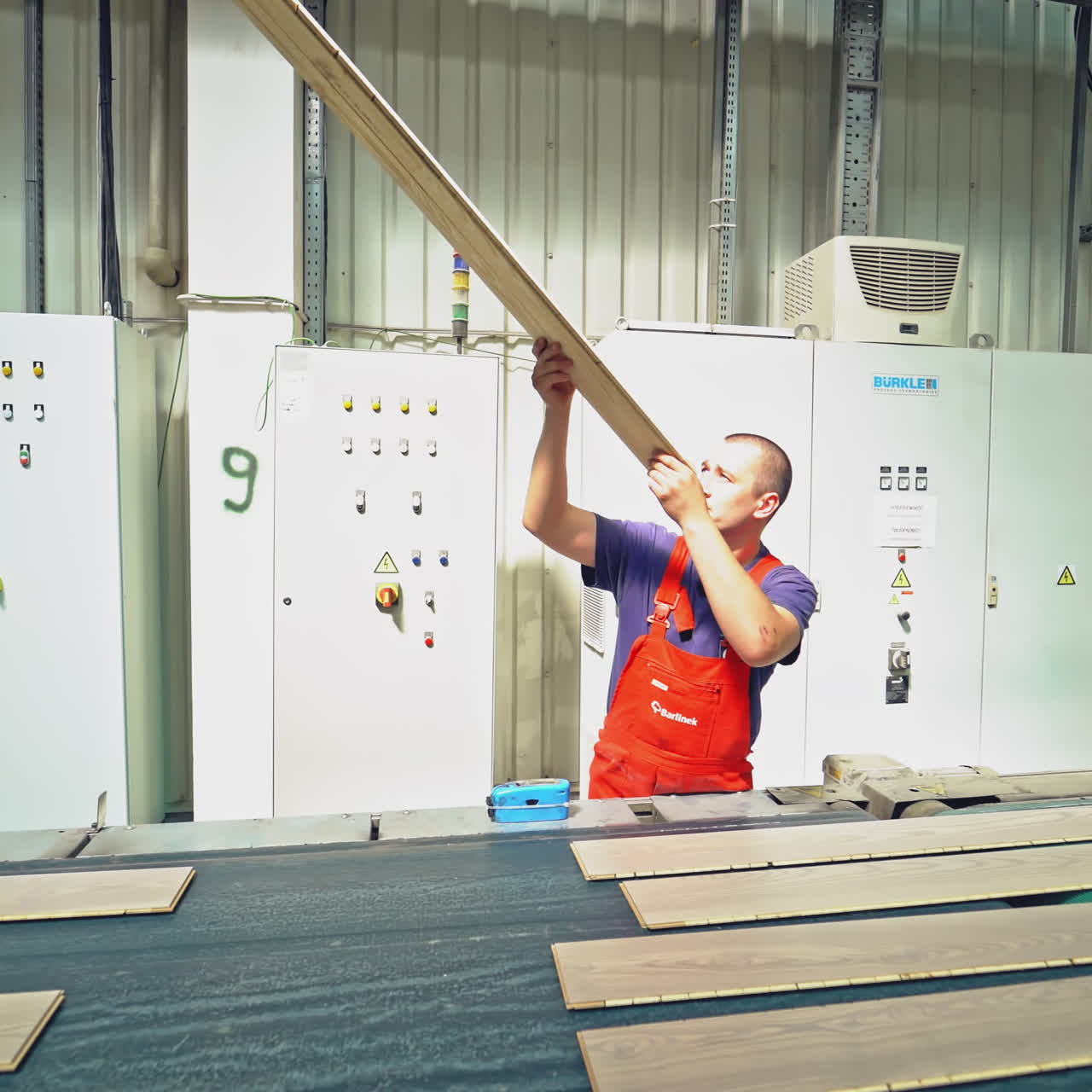 Manufacturing of a parquet board. Floorboard production in the industrial factory. Modern technologies.