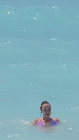 woman swimming in turquoise water