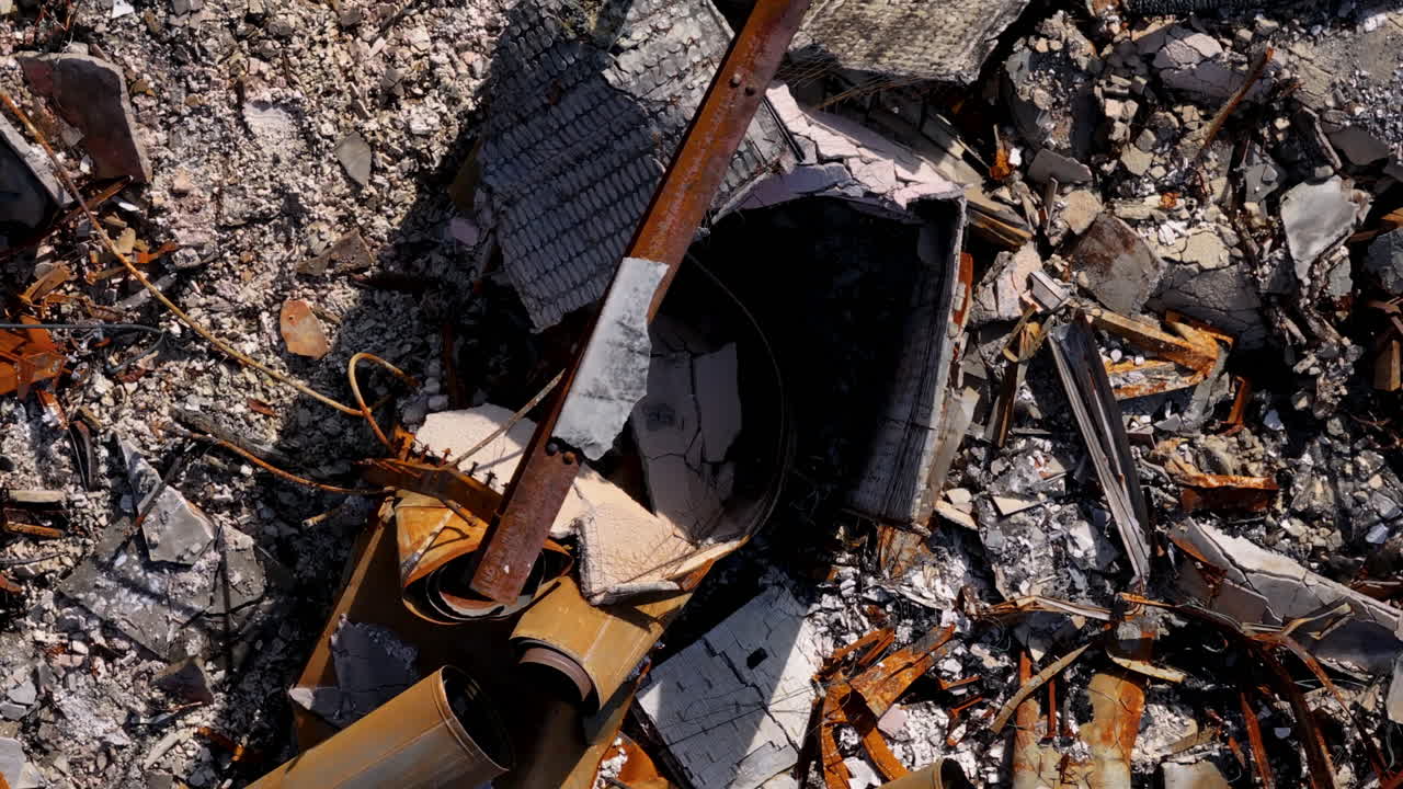 Close-up Aerial View of Building Rubble and Fire Damage