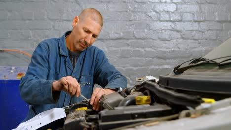 mechanic repairing a car engine 4k