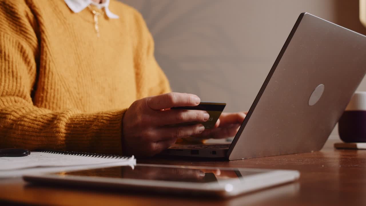 Caucasian woman making online payment using laptop