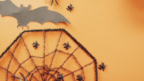 Close-up-of-multiple-halloween-toys-with-copy-space-against-orange-background