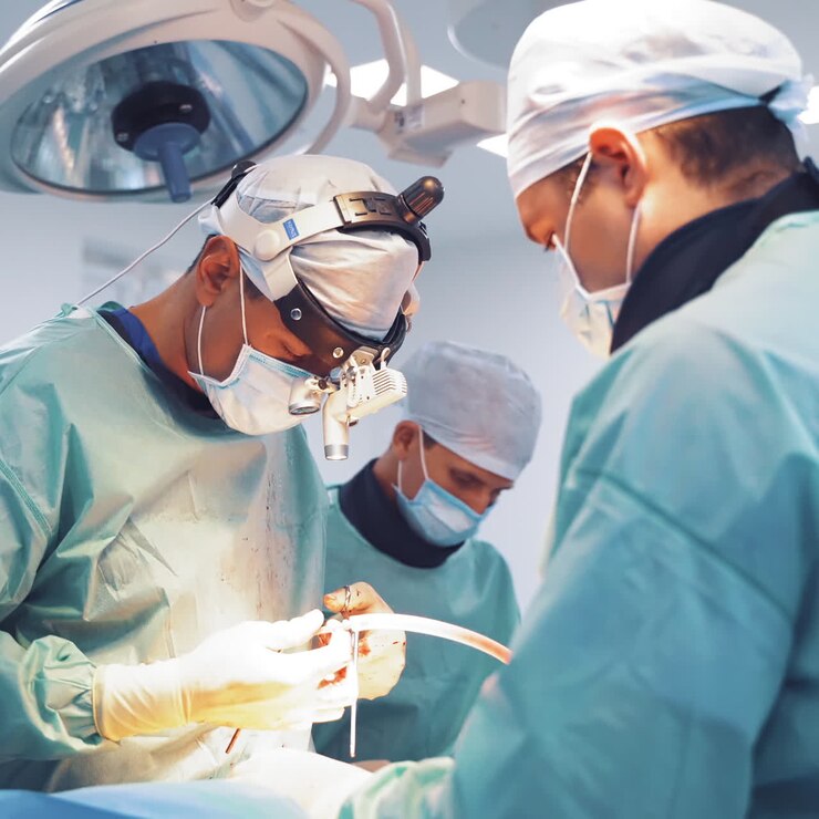 Neurosurgery. Specialist man with assistants during operation. Group of surgeons performing an operation in medical center.