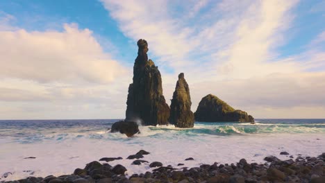 wide shot showing rock formation at shore of madeira island during sunset time - slow motion