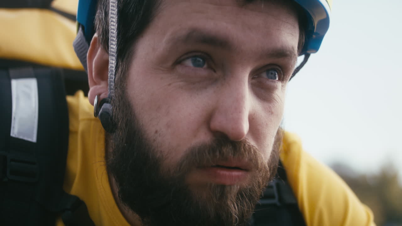 Close-up of a man wearing a helmet and backpack
