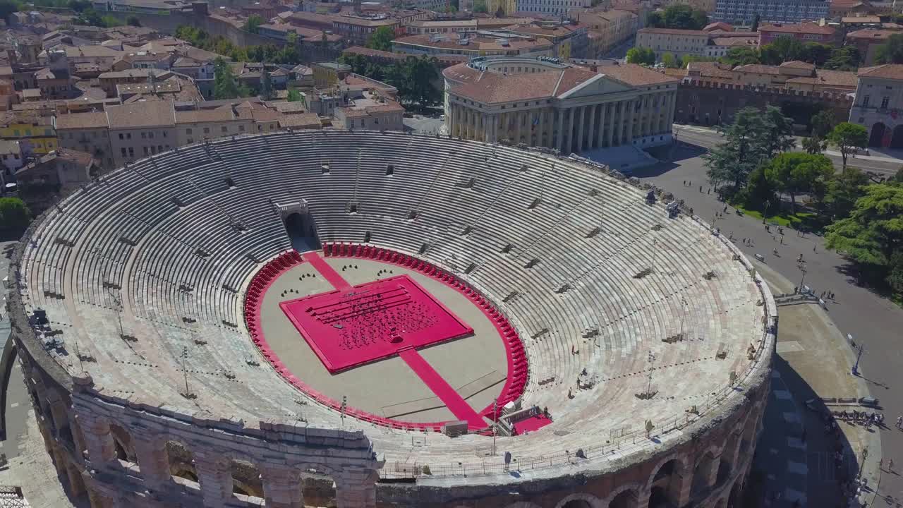 Aerial panoramic view of Arena di Verona, Italy. The drone flies from houses with scooped roofs to the Arena. A view of the Arena and the city opens. 4k vieo.