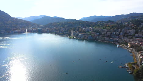 aerial view of a beautiful city on a lake surrounded by mountains
