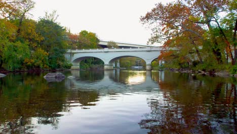 Beautiful-Low-shot-of-bridge-fly-under-autumn