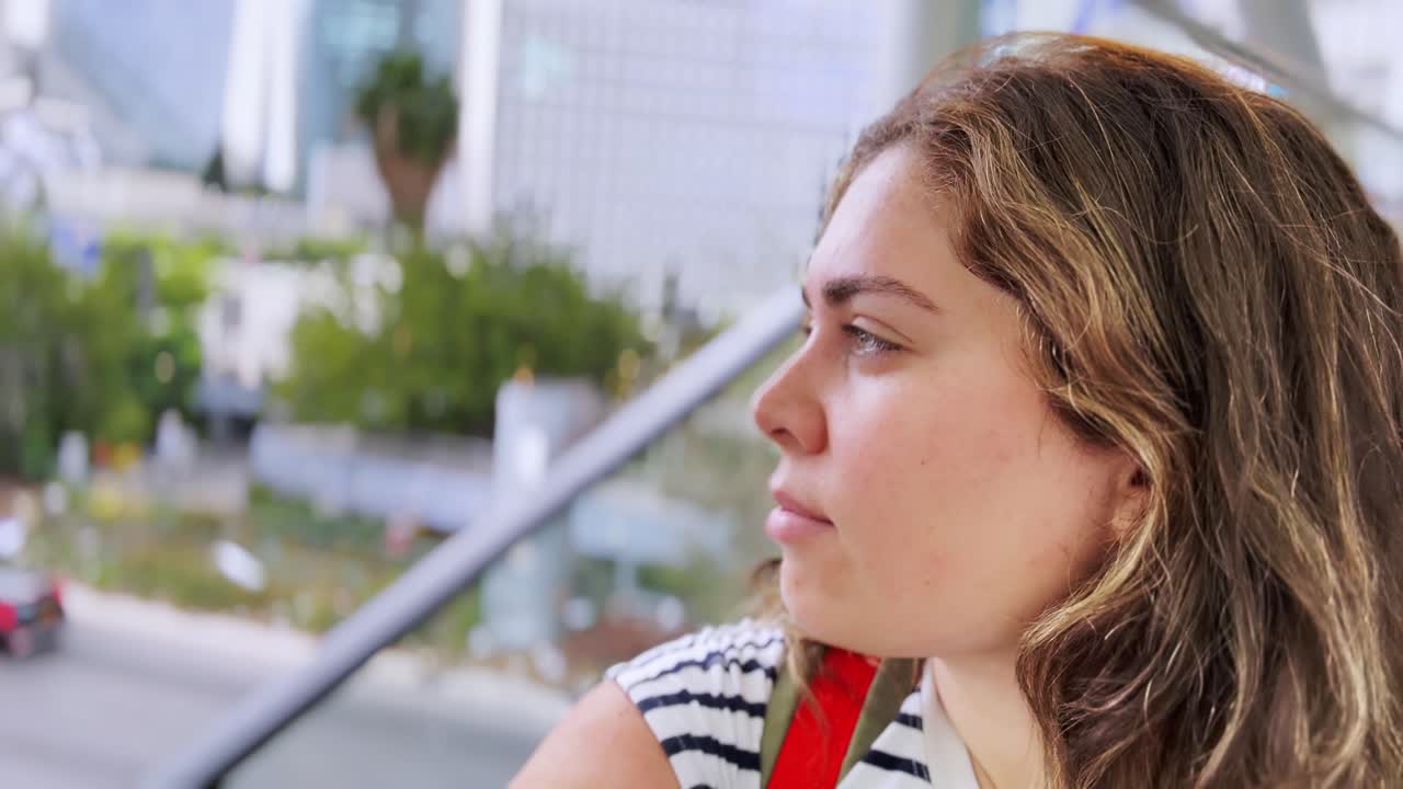 Woman Profile View on Urban Escalator