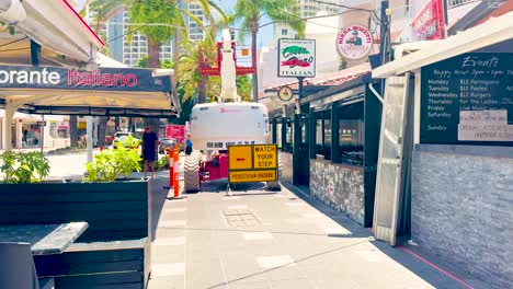 outdoor market scene with food stall and signage