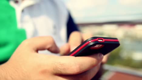 young man using his smartphone in a cafe close up hands 5