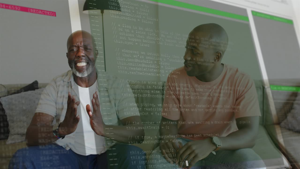 Two men on couch reacting to onscreen code overlay, adult rubbing head, senior explaining bug