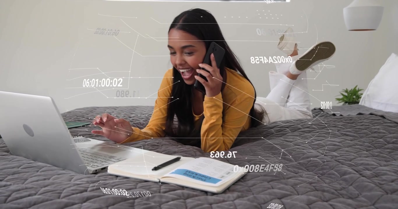 Woman on bed using laptop answering incoming call while taking work notes with timestamp overlay